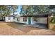 Charming single-story home showcasing a teal front door, carport, and freshly painted white exterior at 25 N Van Buren Ave, Orlando, FL 32811