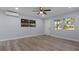 Well-lit living room with light gray walls, wood-look floors, and white trim at 25 N Van Buren Ave, Orlando, FL 32811