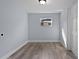 This room has new wood flooring, light gray walls, and a bright window at 25 N Van Buren Ave, Orlando, FL 32811