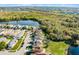 Aerial view of a lakefront neighborhood featuring tree lined streets under a blue sky at 259 Southbridge Cir, Kissimmee, FL 34744