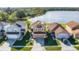 Aerial view of a two-story home with solar panels and a backdrop of a serene lake at 259 Southbridge Cir, Kissimmee, FL 34744