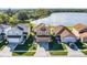 Aerial view of home featuring a lake view, well-maintained lawn, and solar panels on the roof at 259 Southbridge Cir, Kissimmee, FL 34744