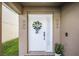 Welcoming front door with wreath, decorative sconces and side window panel at 259 Southbridge Cir, Kissimmee, FL 34744