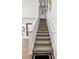 Carpeted stairs with white risers and handrails leading to the upper floor at 259 Southbridge Cir, Kissimmee, FL 34744