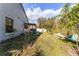 The lawn and patio area are visible next to the home's exterior with overgrown foliage at 2957 Birmingham Blvd, Orlando, FL 32829