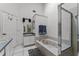 Bright bathroom featuring dual sinks, a large tub, and a glass shower at 2957 Birmingham Blvd, Orlando, FL 32829