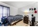 Bedroom featuring tile floors, a twin bed, dark curtains and a cluttered night stand at 2957 Birmingham Blvd, Orlando, FL 32829