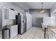 Kitchen area featuring stainless steel refrigerator, ample storage, and adjacent dining space at 2957 Birmingham Blvd, Orlando, FL 32829