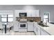 Well-lit kitchen featuring modern white cabinets and stainless steel appliances at 2957 Birmingham Blvd, Orlando, FL 32829