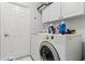 Laundry room with washer, dryer, and ample storage cabinets at 2957 Birmingham Blvd, Orlando, FL 32829