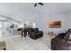 Open-concept living room with tile flooring, vaulted ceiling, and view to the kitchen at 2957 Birmingham Blvd, Orlando, FL 32829