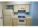 Efficient kitchen featuring white cabinets and appliances at 3008 Parkway Blvd # 302, Kissimmee, FL 34747