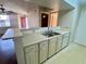 Kitchen with white cabinets, light counters and a stainless steel sink at 3008 Parkway Blvd # 302, Kissimmee, FL 34747