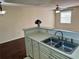 Bright kitchen featuring stainless steel sink and pass through bar at 3008 Parkway Blvd # 302, Kissimmee, FL 34747