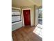 View of the private patio with neutral paint and a red door at 3008 Parkway Blvd # 302, Kissimmee, FL 34747