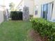 Backyard featuring green grass, a small bush, and a stone pillar at 318 Habitat Way, Sanford, FL 32773