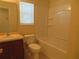 Well-lit bathroom featuring a tub with shower, toilet, vanity and sink at 318 Habitat Way, Sanford, FL 32773