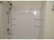 Bathroom shower-tub combo with white tile surround and built-in shelving at 318 Habitat Way, Sanford, FL 32773