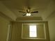 Carpeted bedroom featuring tray ceilings, a ceiling fan, and a large window at 318 Habitat Way, Sanford, FL 32773