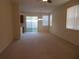 Open living room with carpet floors and sliding glass doors leading to the outside at 318 Habitat Way, Sanford, FL 32773