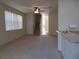 Bright living room with neutral carpet, ceiling fan, and natural light from large window at 318 Habitat Way, Sanford, FL 32773