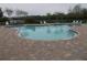 Community pool with lounge chairs, brick pavers and landscaping at 318 Habitat Way, Sanford, FL 32773