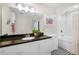 Bright bathroom with a shower-tub combination, dark countertop, and a unique geometric tile floor at 322 E Central Blvd # 1612, Orlando, FL 32801