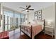 Stylish bedroom featuring a wrought iron bed, expansive windows with urban views, and hardwood floors at 322 E Central Blvd # 1612, Orlando, FL 32801