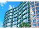 Exterior of a modern condo building with curved design, balconies and large reflective windows at 322 E Central Blvd # 1612, Orlando, FL 32801