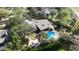 Overhead view of home with a spacious backyard, including a beautiful pool, hot tub, patio, and fire pit at 4124 Winderlakes Dr, Orlando, FL 32835