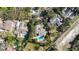 Aerial view of property with a private backyard pool surrounded by mature landscaping and lush greenery at 4124 Winderlakes Dr, Orlando, FL 32835