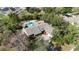 Overhead shot of single-story home with pool and patio, surrounded by trees at 4124 Winderlakes Dr, Orlando, FL 32835