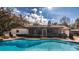 Backyard featuring a refreshing pool with rock accents, screened lanai and outdoor seating at 4124 Winderlakes Dr, Orlando, FL 32835