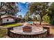 Large backyard featuring a fire pit, a pool and a screened lanai at 4124 Winderlakes Dr, Orlando, FL 32835