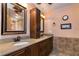 Bathroom features a dual sink vanity with dark wood cabinets and granite counters at 4124 Winderlakes Dr, Orlando, FL 32835