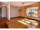 Sunlit dining room with brick accent wall, wood floors, and contemporary light fixture at 4124 Winderlakes Dr, Orlando, FL 32835