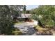 Aerial view of a brick single-story home featuring mature trees, a well-manicured lawn and driveway at 4124 Winderlakes Dr, Orlando, FL 32835