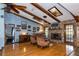 Cozy living room with exposed beams, hardwood floors, a fireplace, and a bar area at 4124 Winderlakes Dr, Orlando, FL 32835