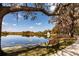 Scenic view of a tranquil pond framed by lush trees with a bench to enjoy the natural landscape at 4124 Winderlakes Dr, Orlando, FL 32835