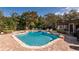 Beautiful backyard pool area with brick patio and mature trees offering shade and privacy at 4124 Winderlakes Dr, Orlando, FL 32835