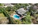 Aerial view of a single-story home with a sparkling pool, patio, and well-maintained landscaping at 4124 Winderlakes Dr, Orlando, FL 32835