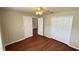 Bedroom boasting hardwood floors with a ceiling fan and a closet at 458 Lancers Dr, Winter Springs, FL 32708