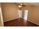 Bedroom with hardwood floors, ceiling fan, and open doorway at 458 Lancers Dr, Winter Springs, FL 32708