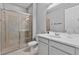 Bathroom featuring a glass-enclosed shower, neutral tiling, and a white vanity with sink and modern fixtures at 4789 Terrace Bluff St, Winter Garden, FL 34787