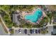 Aerial view of a community pool with lounge chairs, lush landscaping, and convenient parking at 4789 Terrace Bluff St, Winter Garden, FL 34787