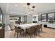 Dining area featuring a white table and modern light fixtures, leading into an inviting living space at 4789 Terrace Bluff St, Winter Garden, FL 34787