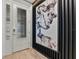 Stylish foyer with a modern door, unique wall decor, and sleek wood flooring, creating an inviting entrance at 4789 Terrace Bluff St, Winter Garden, FL 34787