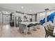 Modern kitchen with white cabinetry, a center island with seating, and stainless steel appliances, seamlessly connected to living spaces at 4789 Terrace Bluff St, Winter Garden, FL 34787