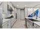 Bright kitchen featuring white cabinetry, stainless steel appliances, and a stylish backsplash, creating a modern design at 4789 Terrace Bluff St, Winter Garden, FL 34787