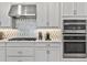 Close up of kitchen featuring stainless steel range hood, gas cooktop, wall oven, and tile backsplash at 4789 Terrace Bluff St, Winter Garden, FL 34787